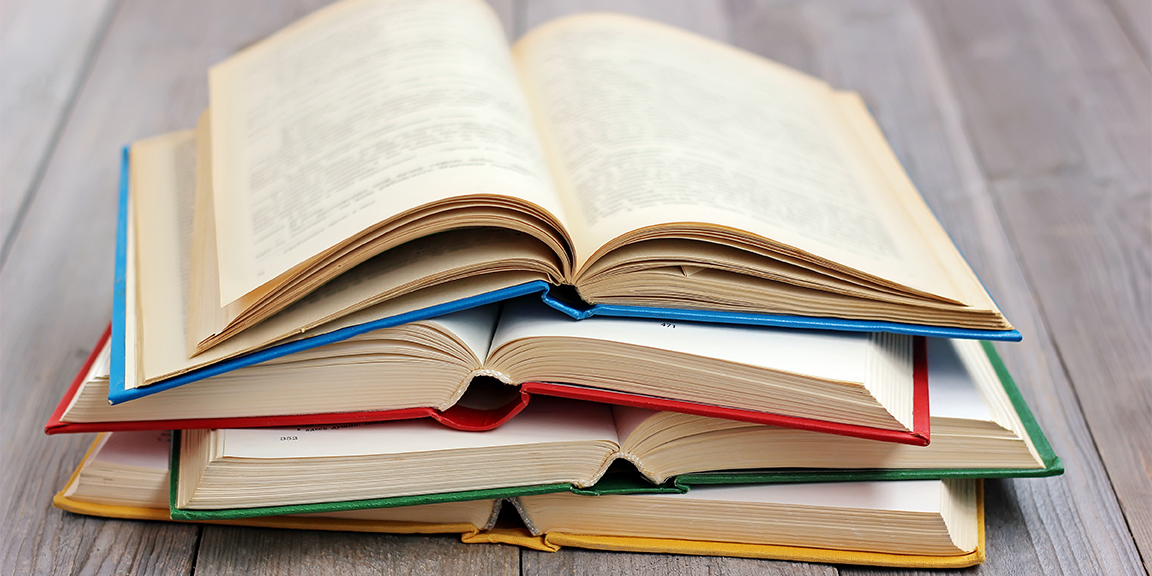 four books stacked and open